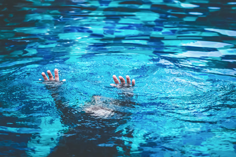 image of a person possibly frozen with fear and unable to move in a body of water