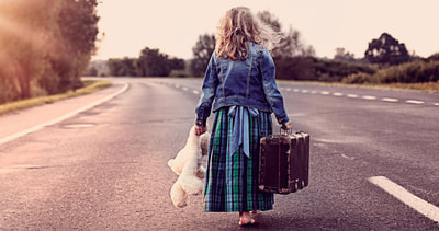 little girl running away from home with suitcase and teddy bear
